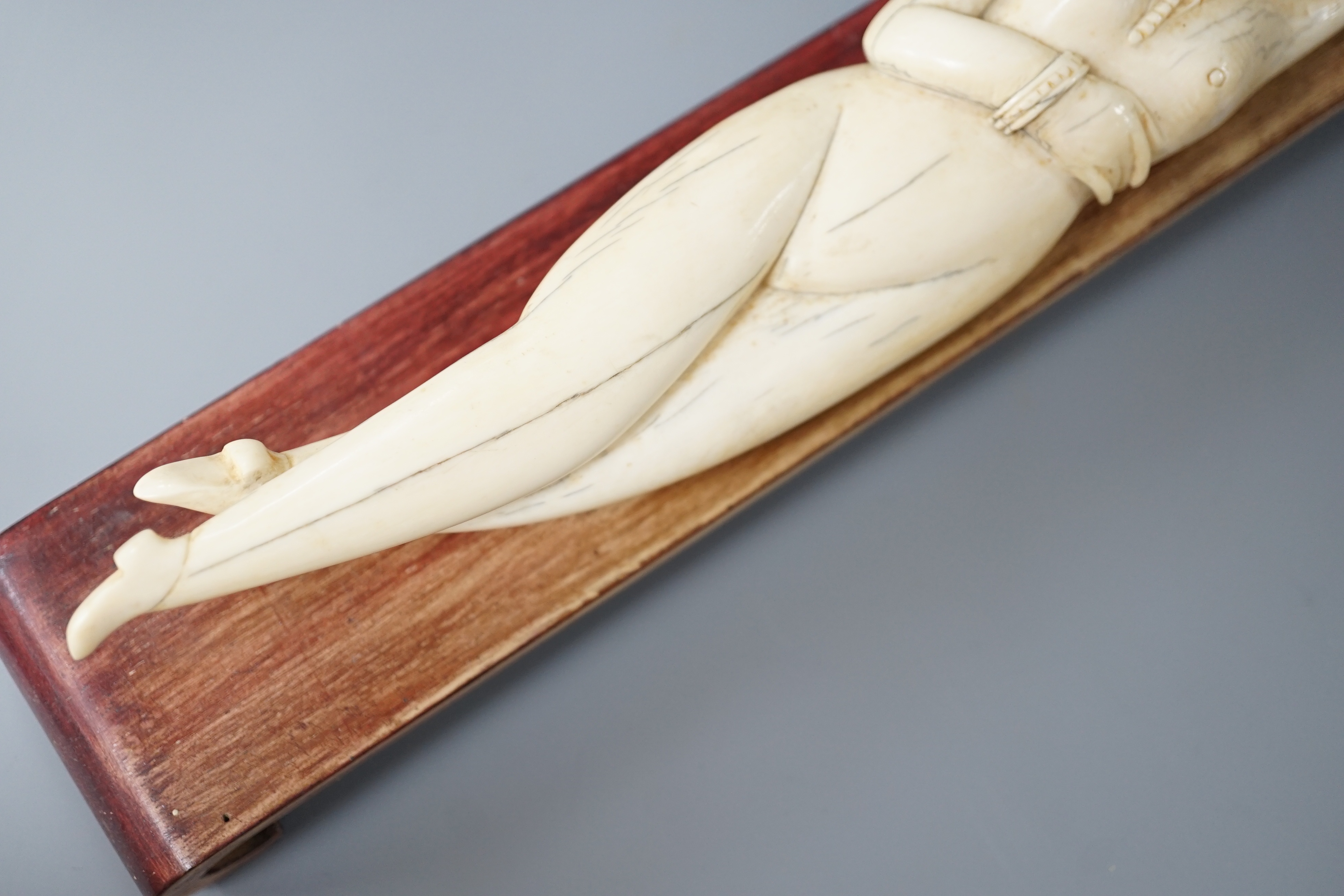A Chinese carved ivory medicine figure, late 19th/early 20th century, wood stand. 25cm excl stand